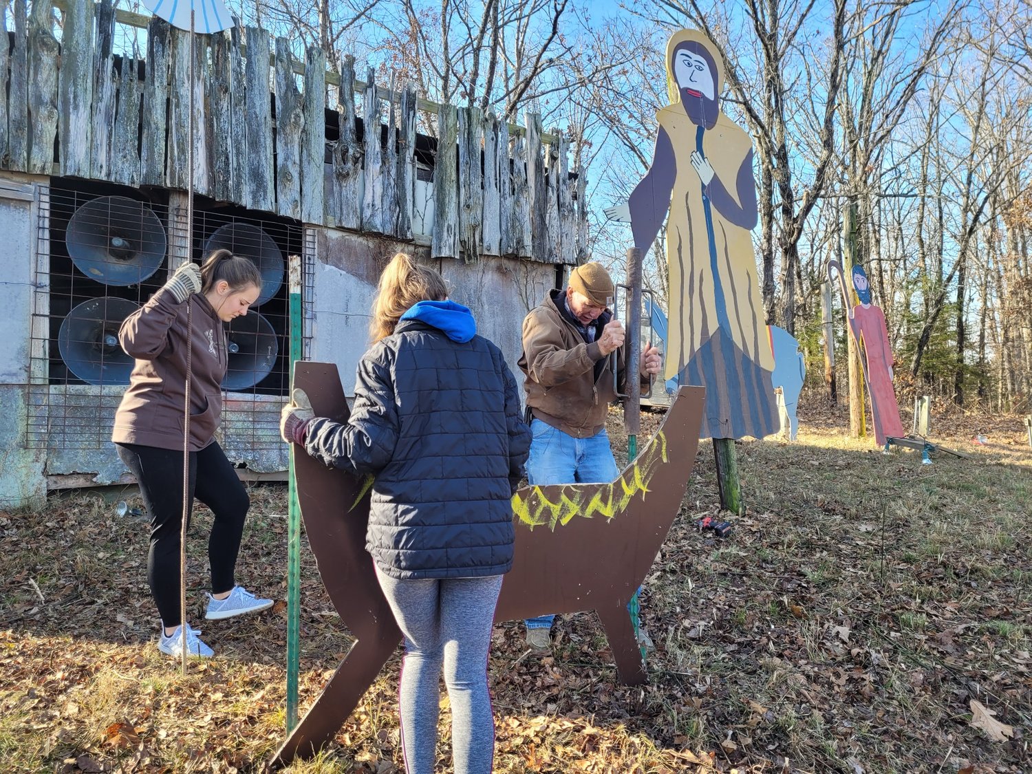 Meta residents place the manger in the center of the hilltop Nativity scene on Dec. 3.